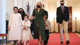 WASHINGTON, DC - NOVEMBER 10: First Lady Dr. Jill Biden holds hands with children of military and veteran caregiving families as she arrives at an event celebrating them in the East Room of the White House on November 10, 2021 in Washington, DC. The event was the first in-person event for First Lady Dr. Jill Biden's Joining Forces initiative. (Photo by Anna Moneymaker/Getty Images)