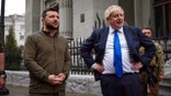 In this image provided by the Ukrainian Presidential Press Office, Ukrainian President Volodymyr Zelenskyy, left, and Britain's Prime Minister Boris Johnson talk during their walk in downtown Kyiv, Ukraine, Saturday, April 9, 2022.
