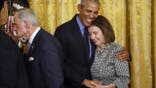 Former President Barack Obama hugs Speaker of the House Nancy Pelosi (D-CA)