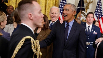 Biden looks on as Democrats gush over Obama at White House event
