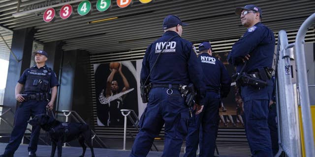 Police officers patrol a subway station in New York, Tuesday, April 12, 2022.