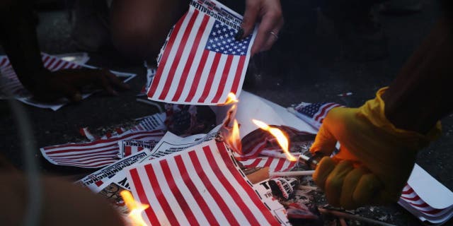 Douglas Murray's 'War on the West' emphasizes the siege of Western culture 2 A group of protesters burn American flags and leaflets with the flag, even as other protesters disagreed with the act, during a protest against racial inequality and police brutality near Black Lives Matter Plaza, during the 4th of July holiday, in Washington, U.S. July 4, 2020. REUTERS/Leah Millis