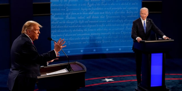 Then-President Donald Trump answers a question as then-Democratic presidential nominee and former Vice President Joe Biden listens during the final presidential debate at the Curb Event Center at Belmont University in Nashville, Tennessee, U.S., October 22, 2020.  
