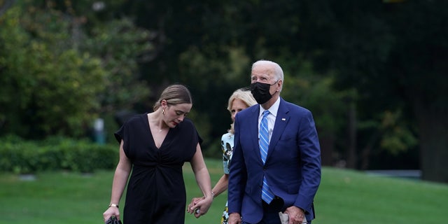US President Joe Biden, US first lady Jill Biden and granddaughter Naomi Biden walk from the Marine One helicopter on the South Lawn to the White House in Washington, US, October 11, 2021. 