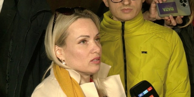 Marina Ovsyannikova, a Channel One employee who staged an on-air protest as she held up a anti-war sign behind a studio presenter, speaks to the media as the leaves the court building in Moscow, Russia March 15, 2022 in this still image taken from a video. REUTERS TV via REUTERS