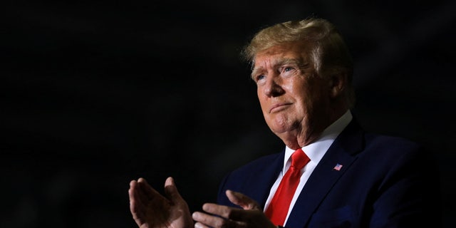 Former U.S. President Donald Trump claps as the crowd cheers him on during a rally in Washington Township, Michigan, U.S. April 2, 2022.