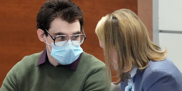 Marjory Stoneman Douglas High School shooter Nikolas Cruz speaks with Assistant Public Defender Melisa McNeill prior to the start of jury pre-selection in the penalty phase of his trial at the Broward County Courthouse in Fort Lauderdale, Florida, U.S. April 4, 2022.