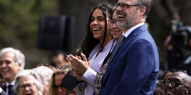 Leila Jackson, daughter of Judge Ketanji Brown Jackson, applauds with her father Patrick Jackson as U.S. President Joe Biden hosts a celebration of Judge Jackson’s confirmation as the first Black woman to serve on the U.S. Supreme Court, on the South Lawn at the White House in Washington.