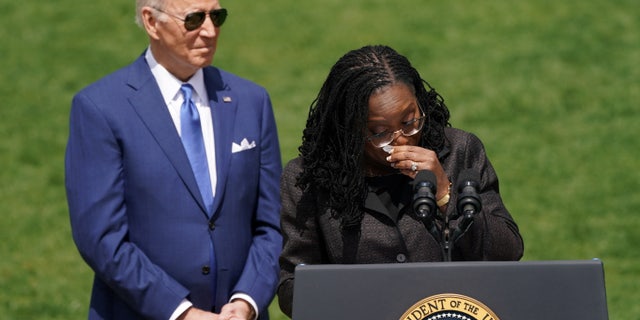 Judge Ketanji Brown Jackson wipes away tears as she speaks in front of U.S. President Joe Biden about her confirmation as the first Black woman to serve on the U.S. Supreme Court during a celebration event on the South Lawn at the White House.