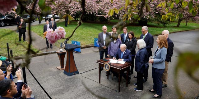 U.S. President Joe Biden signs an executive order intended as an initiative to conserve old-growth forests in federal lands, after delivering remarks about climate change and protecting national forests on Earth Day, at Seward Park in Seattle, Washington, U.S. April 22, 2022.
