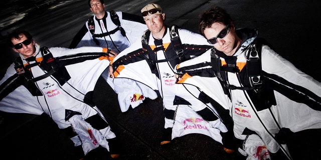 SEATTLE, WA - JUNE 10, 2010: Red Bull Air Force paratroopers Luke Aikens, Jon Devore, Andy Farrington, and Miles Daisher prepare to set sail for downtown Seattle in June 10, 2010, in suit. Washington. (Photo by Christian Pondella / Getty Images)