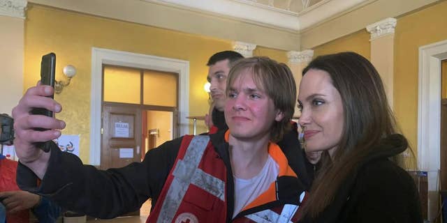 Angelina Jolie, Hollywood movie star and UNHCR goodwill ambassador, poses for photo with her fans in Lviv, Ukraine, Saturday, April 30, 2022.