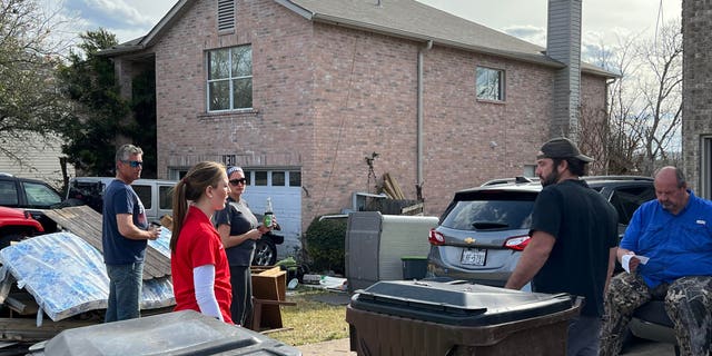 Caroline Harris helps out after a tornado struck their community in April 2022.