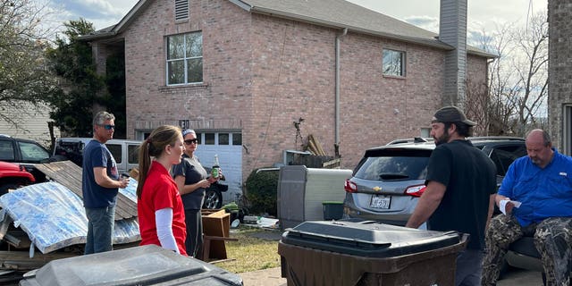 Caroline Harris helps out after a tornado struck their community in April 2022.
