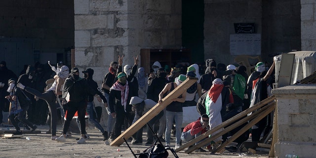 Palestinians clash with Israeli security forces at the Al Aqsa Mosque compound in Jerusalem's Old City on Friday, April 15, 2022.