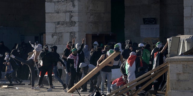 Palestinians clash with Israeli security forces at the Al Aqsa Mosque compound in Jerusalem's Old City Friday, April 15, 2022.