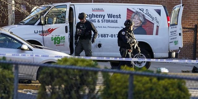 Bomb squad personnel search a U-Haul van during an ongoing investigation in the Brooklyn borough of New York, Tuesday, April 12, 2022.