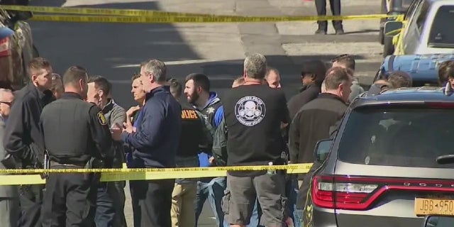 Authorities at the scene of a shooting in which a Yonkers, New York police officer was shot and a suspect was killed. A Yonkers police officer was shot Wednesday while trying to arrest three suspects during a joint investigation with the FBI. The suspect was killed when an FBI agent returned fire.