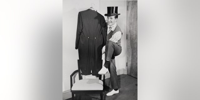 Pat Boone flaunts his top hat, white tie and tails in New York, on Oct. 30, 1958, as he was gearing up for a trip to London to headline a royal command performance for Queen Elizabeth II.