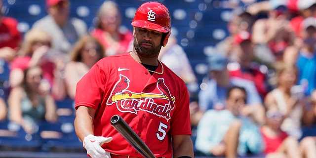 St. Louis Cardinals' Albert Pujols (5) looks at his bat in the first inning of a spring training baseball game against the Washington Nationals, Wednesday, March 30, 2022, in West Palm Beach, Fla.