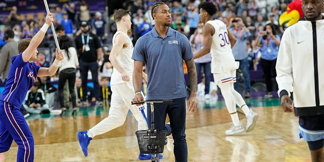 Injured Villanova guard Justin Moore arrives for a game against Kansas in the Final Four of the NCAA tournament Saturday, April 2, 2022, in New Orleans. 