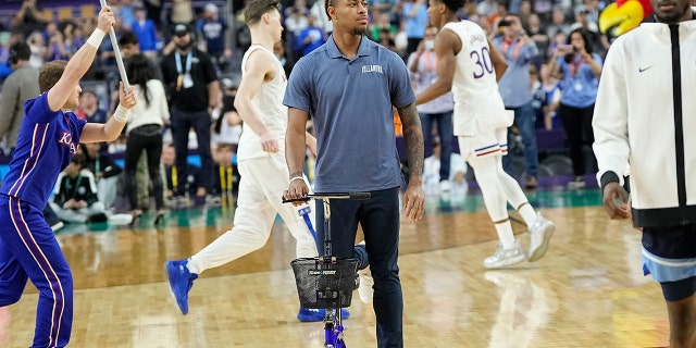 Injured Villanova guard Justin Moore arrives for a game against Kansas in the Final Four of the NCAA tournament Saturday, April 2, 2022, in New Orleans. 