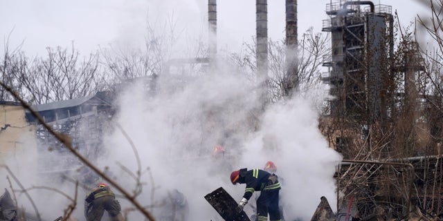 Ukrainian firefighters work at a scene of a destroyed building after shelling in Odesa, Ukraine, Sunday, April 3, 2022.