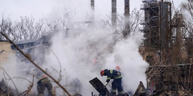 Ukrainian firefighters work at a scene of a destroyed building after shelling in Odesa, Ukraine, Sunday, April 3, 2022.