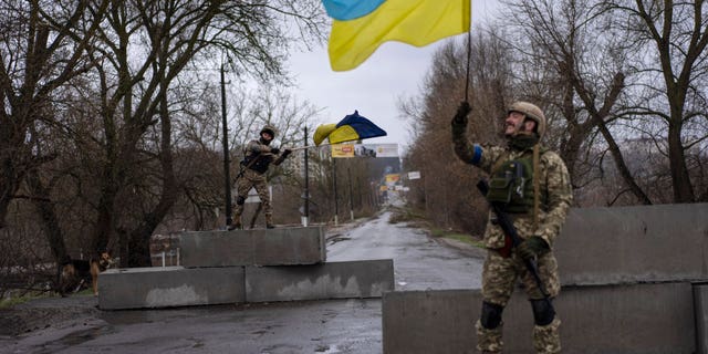 Ukrainian soldiers celebrating at a checkpoint in Bucha, on the outskirts of Kyiv, Ukraine, April 3.