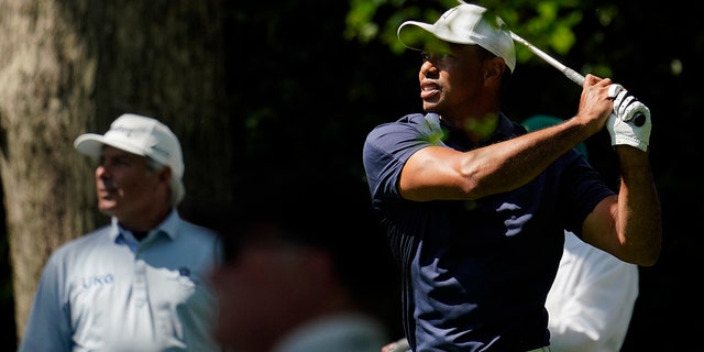 Fred Couples watches as Tiger Woods tees off on the second hole during a practice round for the Masters golf tournament on Monday, April 4, 2022, in Augusta, Ga.