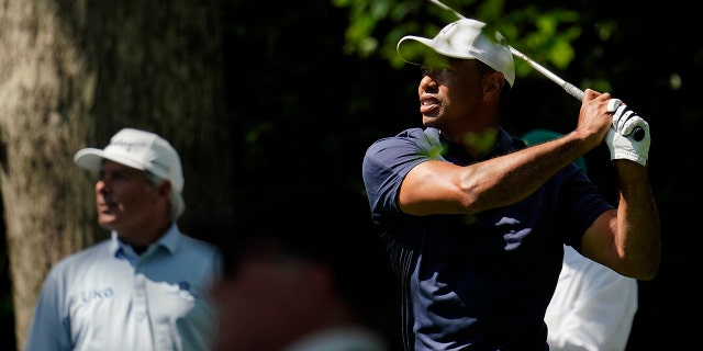 Fred Couples watches as Tiger Woods tees off on the second hole during a practice round for the Masters golf tournament on Monday, April 4, 2022, in Augusta, Ga.
