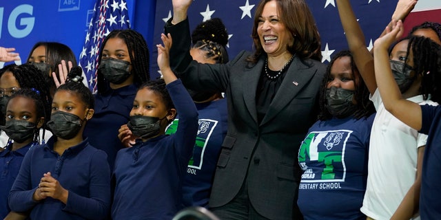 Vice President Kamala Harris poses for a photo with students at Thomas Elementary School in Washington, Monday, April 4, 2022. (AP Photo/Susan Walsh)
