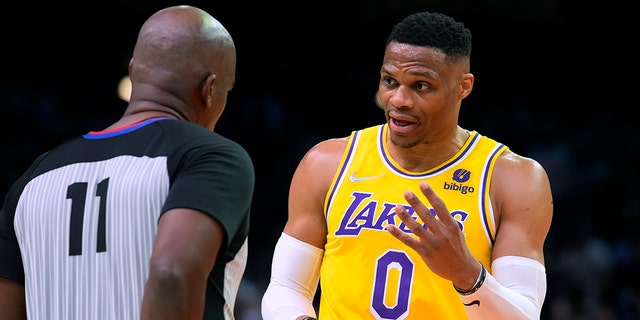Los Angeles Lakers guard Russell Westbrook (0) talks to referee Derrick Collins (11) during the second half of the team's NBA basketball game against the Phoenix Suns, Tuesday, April 5, 2022, in Phoenix. The Suns won 121-110. 