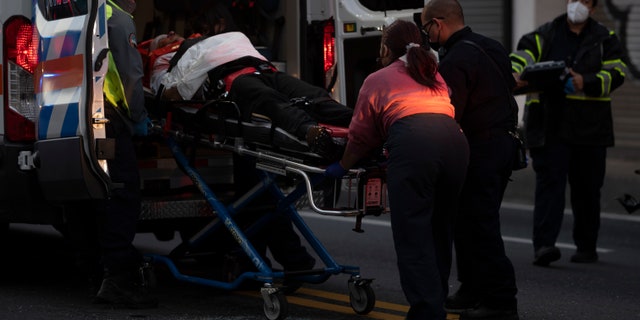 First responders give medical assistance to a driver on R.H. Tood Avenue after a car crash near an intersection during a blackout in San Juan, Puerto Rico, early Thursday, April 7, 2022. 