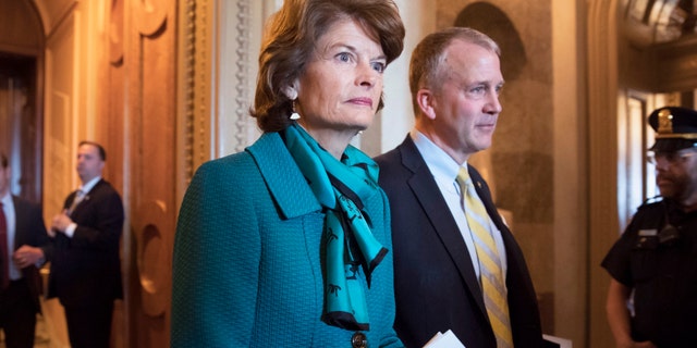 FILE - Sen. Lisa Murkowski, R-Alaska, and Sen. Dan Sullivan, R-Alaska, leave the chamber after a vote on Capitol Hill in Washington on May 10, 2017. 