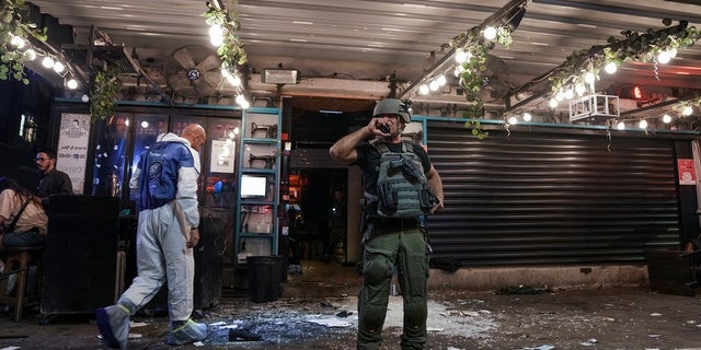 Israeli police inspect the scene of a shooting attack In Tel Aviv, Israel on Thursday. Israeli police say several people were wounded in a shooting in central Tel Aviv. The shooting on Thursday evening occurred in a crowded area with several bars and restaurants.