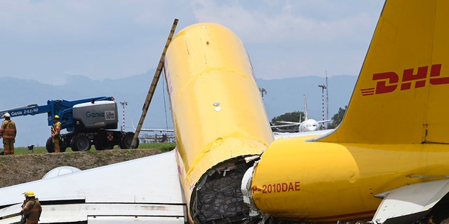 A cargo jet that spun off lays broken on the runway of the Juan Santamaria International Airport in Alajuela, Costa Rica, Thursday, April 7, 2022.
