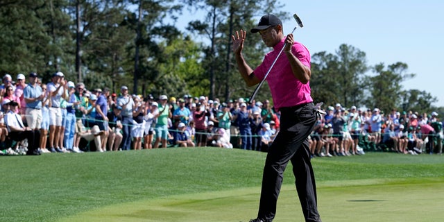 Tiger Woods acknowledges applause on the 18th green after finishing the first round at the Masters golf tournament on Thursday, April 7, 2022, in Augusta, Ga.