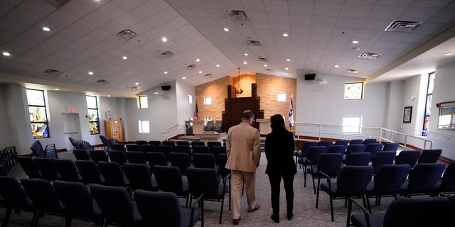 Rabbi Charlie Cytron-Walker, left, and Anna Salton Eisen walk in Congregation Beth Israel in Colleyville, Texas, Thursday, April 7, 2022. 