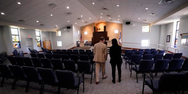 Rabbi Charlie Cytron-Walker, left, and Anna Salton Eisen walk in Congregation Beth Israel in Colleyville, Texas, Thursday, April 7, 2022. 