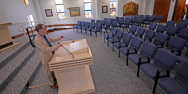 Rabbi Charlie Cytron-Walker adjusts the microphones while testing the sound system at Congregation Beth Israel in Colleyville, Texas, Thursday, April 7, 2022.