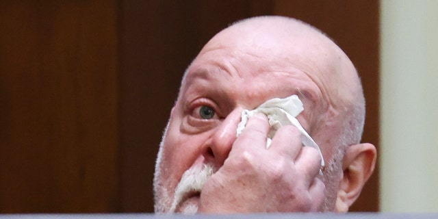 Isaac Baruch wipes tears as he gets emotional while he testifies during Johnny Depp's defamation trial against his ex-wife Amber Heard at the Fairfax County Circuit Courthouse in Fairfax, Virginia, U.S., April 13, 2022.