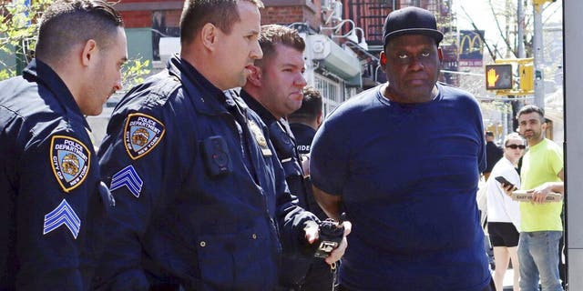 New York City Police Department officers arrest subway shooting suspect Frank James in the East Village Wednesday, April 13, 2022. 