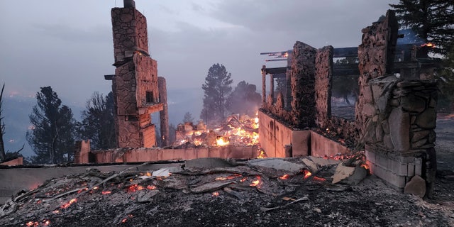The remains of a home left after a wildfire spread through the Village of Ruidoso, New Mexico, on Wednesday, April 13, 2022.