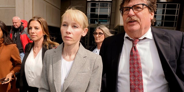 Sherri Papini of Redding leaves the federal courthouse accompanied by her attorney, William Portanova, right, after her arrangement in Sacramento, Calif., Wednesday, April 13, 2022.