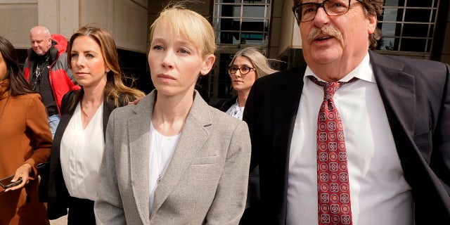 Sherri Papini of Redding leaves the federal courthouse accompanied by her attorney, William Portanova, right, after her arrangement in Sacramento, Calif., Wednesday, April 13, 2022.