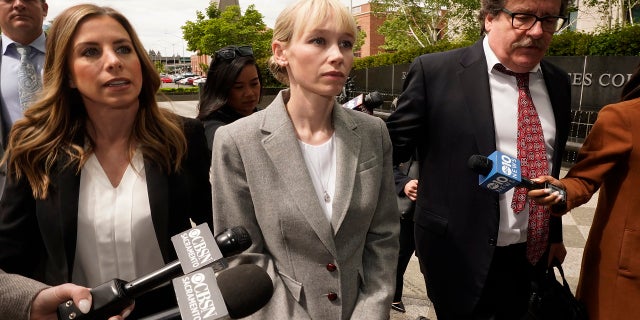 Sherri Papini of Redding walks to the federal courthouse accompanied by her attorney, William Portanova, right, in Sacramento, Calif., Wednesday, April 13, 2022. 