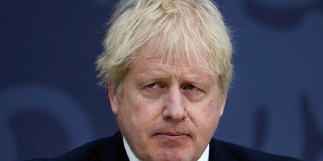 British Prime Minister Boris Johnson delivers a speech at Lydd Airport, south east England, Thursday, April 14, 2022. Britain says it has struck a deal with Rwanda to send some asylum-seekers to the central African country, a proposal that has been condemned by opposition politicians and refugee groups. (AP Photo/Matt Dunham, Pool)