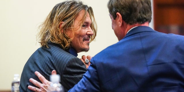 US Actor Johnny Depp (L) sits with his legal team during the 50 million US dollars Depp vs Heard defamation trial at the Fairfax County Circuit Court in Fairfax, Virginia, USA, 14 April 2022.