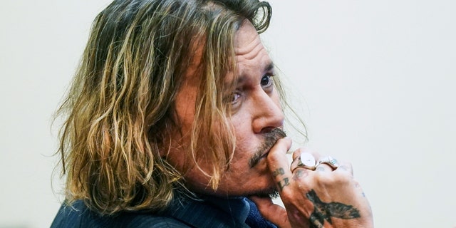 US actor Johnny Depp looks over his shoulder as he sits in the courtroom during the 50 million US dollars Depp vs Heard defamation trial at the Fairfax County Circuit Court in Fairfax, Virginia, USA, 14 April 2022. Johnny Depp's 50 million US dollars defamation lawsuit against Amber Heard that started on 10 April is expected to last five or six weeks.